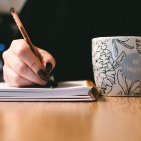 woman making notes in book